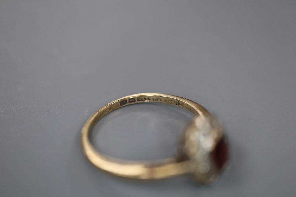 A 1970s 9ct gold, garnet and white sapphire? set oval cluster ring, size L, gross 1.6 grams.